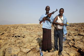 Two policemen with guns in the geothermal area of Dallol, hot climate, Dallol, Ethiopia
