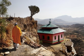 Monk wanders past grave church with breathtaking views, Debre Damo, Tigray, Ethiopia