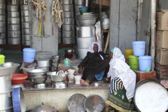 Traditional shop stand in the old town of Harar with kitchenware and colorful buckets, Harar,