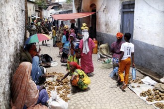 Market scene in an alley in Harar with colorful clothes and goods, Harar, Ethiopia