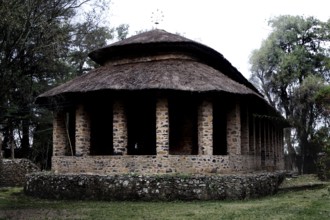 Stone church with round roof and columns in Debre Berhan Selassie