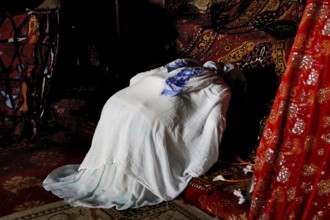 Worshippers inside Debre Berhan Selassie church, wrapped in cloth, in Gondar, Gondar, Ethiopia