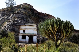Entrance to Debre Mariam Krokor rock church in front of a steep rock face in natural surroundings,