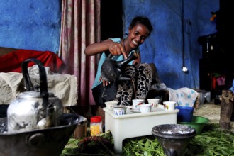 Woman serves coffee in traditional ceremony in Lalibela, Lalibela, zero