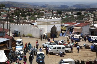 The Shoa Ber West Gate of Harar surrounded by busy markets and vehicles, Harar, Harari, Ethiopia