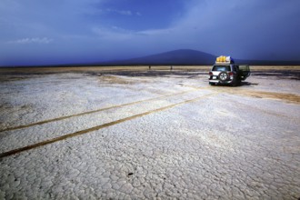 Land cruiser in a barren desert landscape with mountain views, Kusrawad, Ethiopia