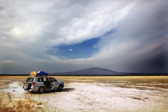 Landcruiser stands in a vast landscape with dramatic skies, zero