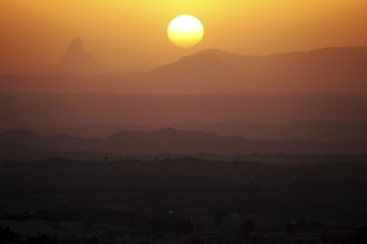 Sunset over a hilly landscape with intense warm colors, Hawzien, Gheralta, Ethiopia