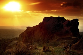 Rock formation at sunset creates a breathtaking landscape with golden sky tones, Hawzien, Tigray,