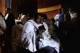 Believers read Bete Gabriel and Raphael during a service in the church, Lalibela, Amhara, Ethiopia