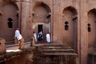 People wearing traditional clothing in the impressive Bete Gabriel Raphael Rock Church, Lalibela,