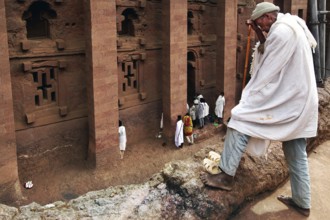 Pilgrim enters the imposing rock church of Bete Medhane Alem in Lalibela. The scene appears calm