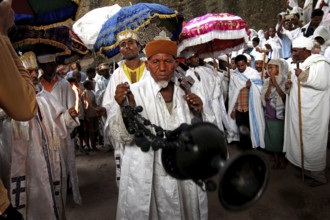 Procession with a man holding incense surrounded by people, Lalibela, Amhara, Ethiopia