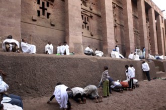 People wearing white robes pray at the Bete Medhane Alem Rock Church during Easter, Lalibela,