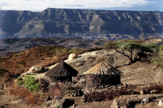 Traditional round huts against the majestic backdrop of the Lasta Mountains, Lalibela, Amhara,