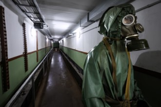 A walk in the Zemaitija National Park bunker with a figure wearing a protective suit, Plokstine,