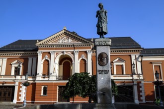 Historic theatre on Theatre Square with the Angel of Tharau statue in the old town, Klaipeda,