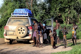 Children and a land cruiser in a Hamer village, Turmi, Ethiopia