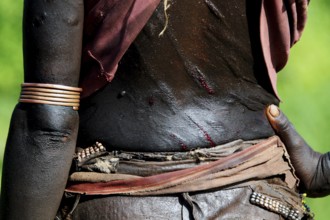 Close-up view of a Hamer initiation ritual with visible scars and traditional jewelry, Turmi,