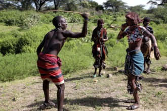 Hamer woman whipping, part of a ceremonial initiation ritual, in the nature of Turmi, Turmi,