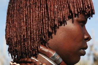 Hamer woman with artfully braided hair in a village in Turmi, Turmi, Ethiopia