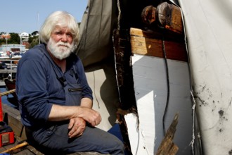 Shipyard workers on Mellemværftet in Kirkelandet next to a boat in sunny weather, Kristiansund,