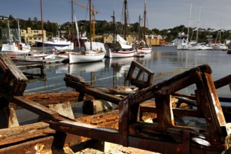 Mellemværftet shipyard in Kirkelandet with sailboats and old wooden parts in the foreground,