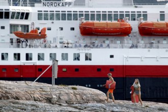 Hurtigruten ship in Kristiansund, dock with passengers and distinctive red lifeboats, Kristiansund,