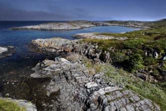 Rugged rocky coast with views from Eldhusøya across the sea near Lyngholmen, Atlanterhavsveien,
