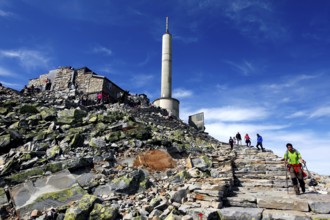 The ascent to the Gaustatoppen summit plateau, rock trails lead to the distinctive tower, zero