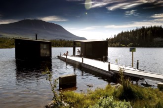 View of the lake from Gaustablikk with jetty and sauna, rolling mountains in the background, zero
