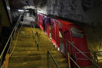 Steep stairs to the entrance to the Gaustabanen cable car, red wagons in a cave, zero