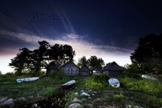 Romantic fishing sheds on Altja beach at dusk, Altja, Estonia