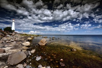 A lighthouse on the rocky coast of Tahkuna with impressive skies, Hiiumaa, Tahkuna, Estonia