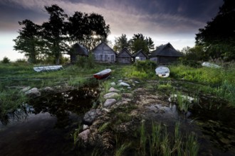 Fishing sheds and boats on the quiet beach of Altja at dusk, Altja, Estonia