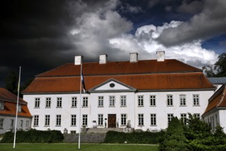 Large historic manor house with dramatic cloudy sky, Suuremäisa, Hiiumaa, Estonia