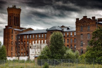 Old brick building of the Kreenholm textile factory in Narva under a threatening sky, Narva,