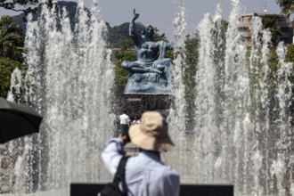 Urakami Peace Park with spray fountain and peace statue, visitors in the foreground, Nagasaki,