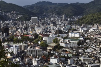 Dense city view of Nagasaki from Nakanmuriyama with mountains in the background, Nagasaki, Japan