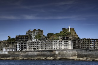Abandoned building on Gunkanjima island with dramatic sky in the background, Nagasaki, Kyushu,