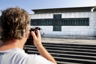 Martyr memorial with a photographer in the foreground, steps leading to the impressive building,