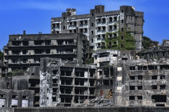 Impressive shot of Gunkanjima's crumbling urban structure seen from the sea, Nagasaki, Kyushu,