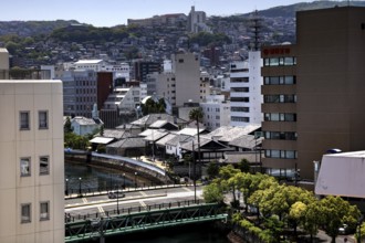 View of the Dutch trade base Dejima with modern buildings and surrounding landscape, Nagasaki,