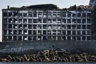 Close-up of dilapidated building structures on Gunkanjima reflecting history and decay, Nagasaki,