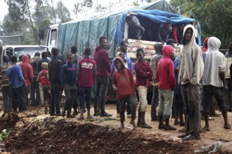 Group of people gather around a truck on a muddy road, Yirga Alem, Yabello, Ethiopia