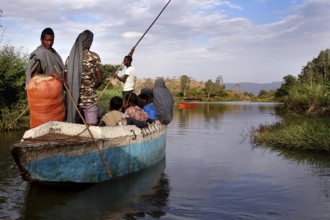 Ferry with people on a river against a scenic backdrop, Blue Nile, Ethiopia