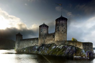 Olavinlinna Castle in Savonlinna against dramatic sky and water, Savonlinna, South Savo, Finland