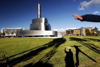 Modern Northern Lights Cathedral in Alta with long shadows on the meadow, Alta, Finnmark, Norway