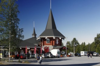 Santa Claus village building with pointed tower and bright red façade, Napapiiri, Finland