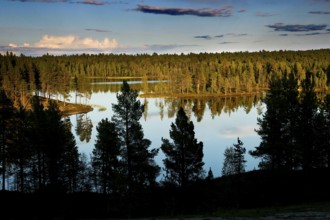 Reflecting lake landscape at dusk in Lapland, Lapland, Finland
